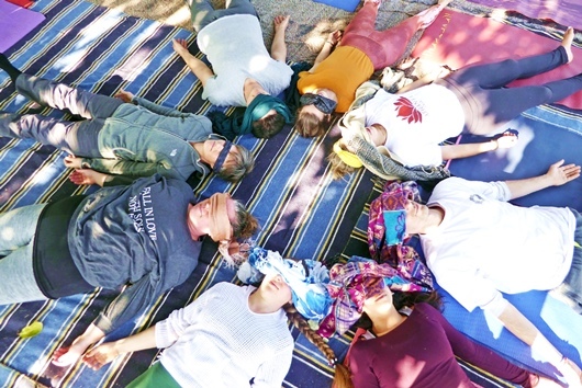During YTT in Arhanta Yoga Ashram, students relaxing in Yoga Nidra together YTT Students lying in a circle with their eyes covered, practicing Yoga Nidra