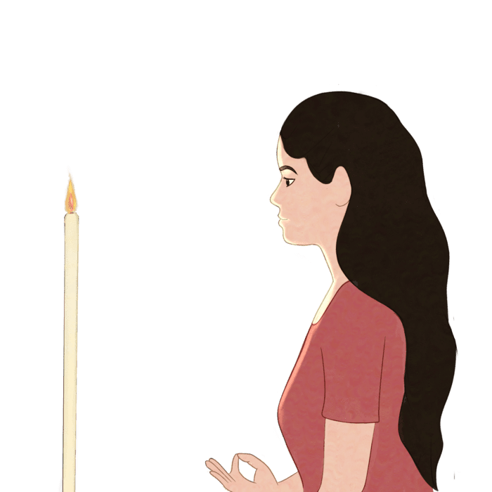 A young Indian woman gazes at a lit candle to purify and strengthen the eyes. A young Indian woman gazes at a lit candle to purify and strengthen the eyes.