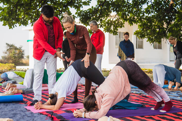 Arhanta Yoga students complete practical asana skills training at an intensive yoga teacher training course in India 