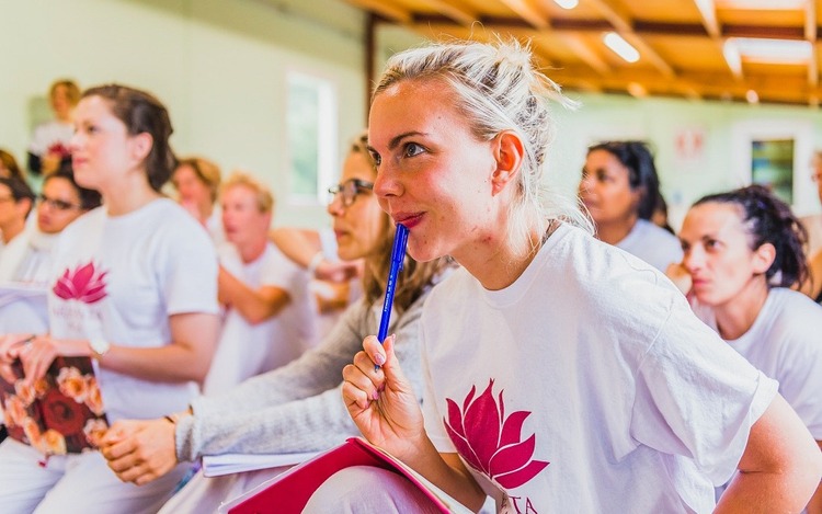 Yoga students taking notes in Jnana philosophy class Yoga students during a Jnana yoga philosophy class