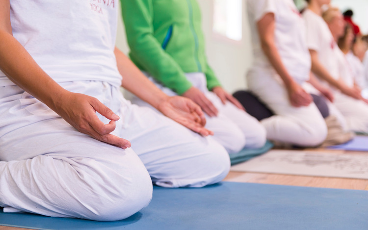 Yoga students sit in meditation position with Chin Mudra, practicing Bhastrika Pranayama for weight loss and metabolism