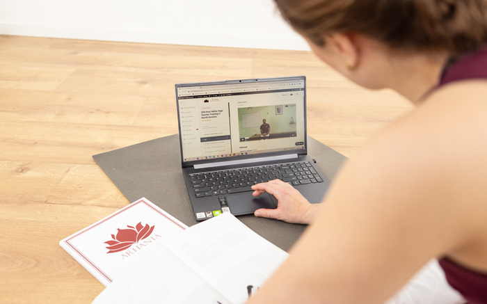 A woman learns how to do yoga at home A woman learns how to do yoga at home