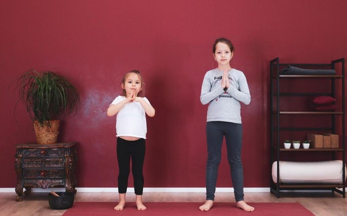 Two children practice mindful kids yoga poses