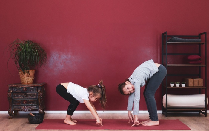 Two children practice mindful yoga for kids
