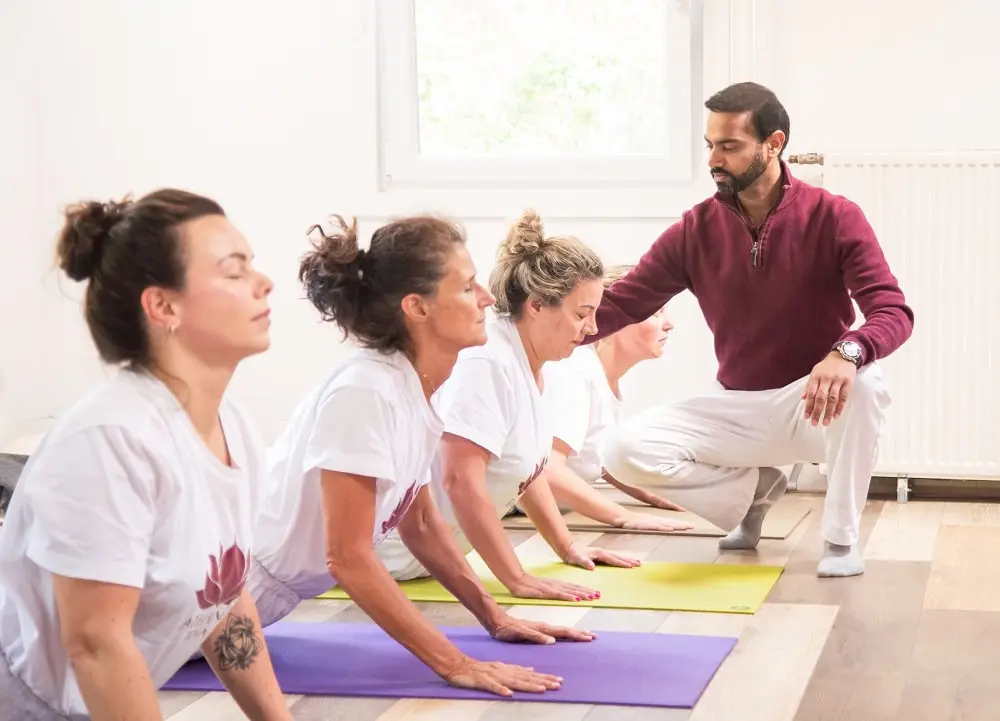 Dr. Ram Jain training students during YTT Course session 200-hour yoga teacher training instructor guiding students in a Netherlands ashram class
