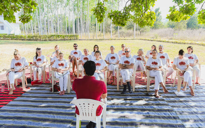 A group of yoga practitioners brainstorm their personal brand and business plan in a yoga business coaching course