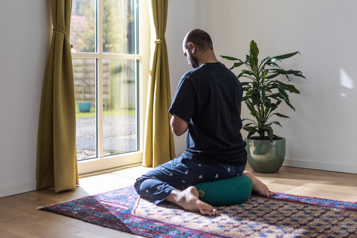 A yoga practitioner creates an at-home yoga space A yoga practitioner creates an at-home yoga space