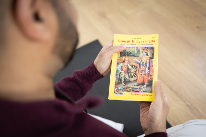 Yoga practitioner reads about enlightenment in the Bhagavad Gita Yoga practitioner reads about enlightenment in the Bhagavad Gita