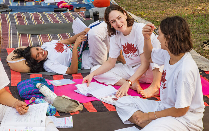 A sangha, or yoga community, gather outside
