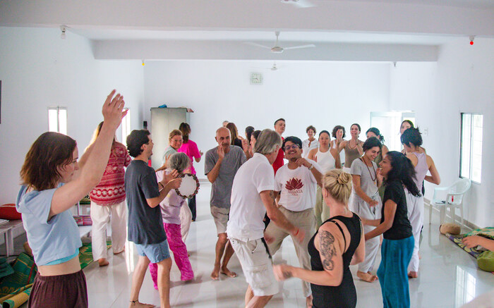 A yoga sangha dance and chant together