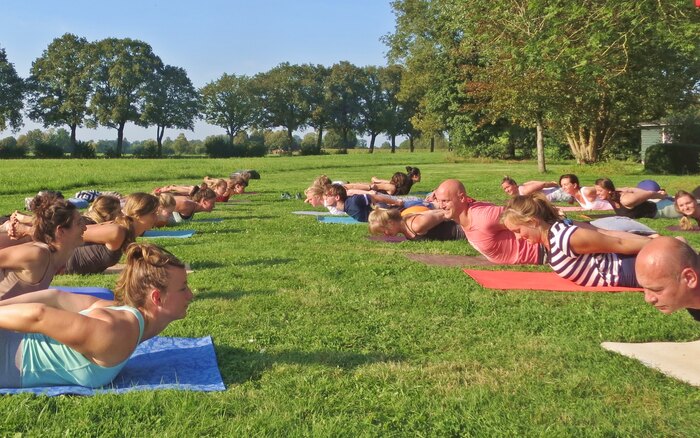 Arhanta yoga community practice Hatha yoga poses outside