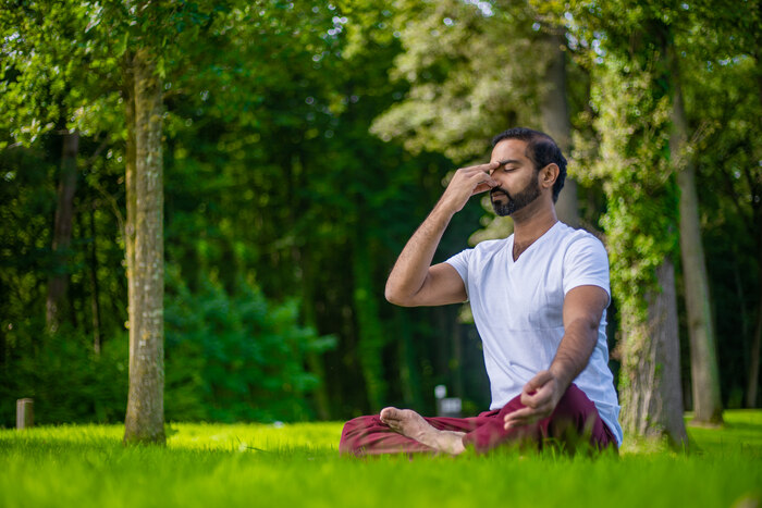 Yoga practitioner practices alternate nostril breathing Yoga practitioner practices alternate nostril breathing