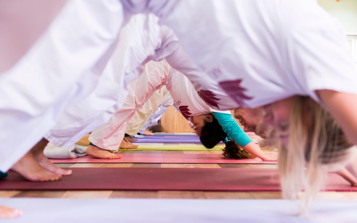 Yoga students practice yoga transitions