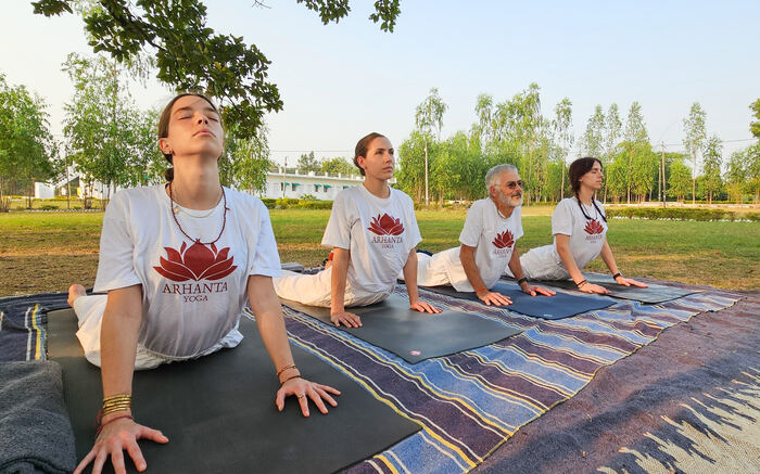 Yoga students transition from Chaturanga to Upward-Facing Dog