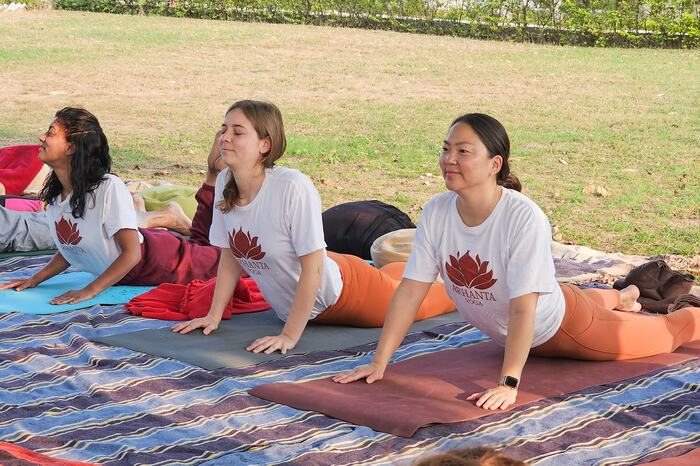 A group of yoga students practice restorative yoga poses for burnout relief