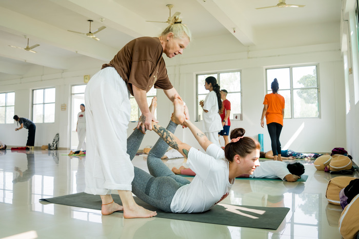 Yoga practitioners meditate in a yoga class Yoga practitioners meditate in a yoga class