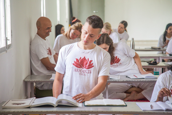 Yoga student reads a yogic text