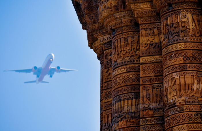 Airplane flying over a temple in India