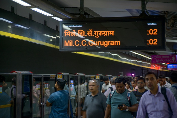 Commuters at a metro station in Delhi