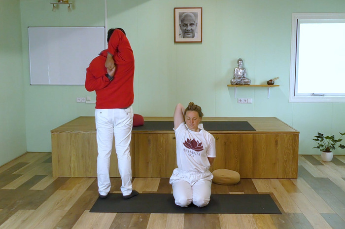 Yoga teacher teaching cow face pose Yoga teacher teaching cow face pose