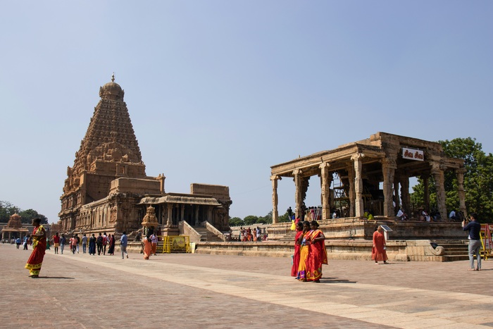 Tourists and locals in traditional clothing at a temple in India