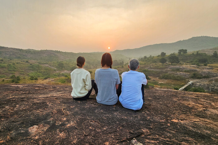 Yoga practitioners reflect in nature during Makar Sankranti