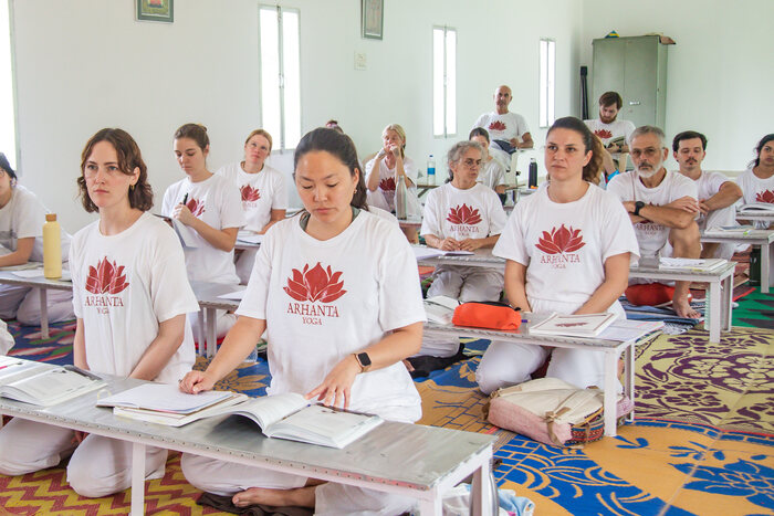 Yoga students listen in a yoga philosophy class