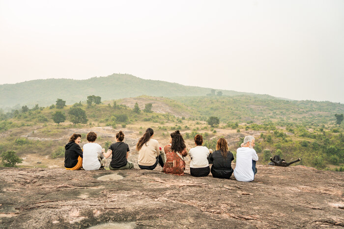 Yoga students sit together in the Indian countryside Yoga students sit together in the Indian countryside