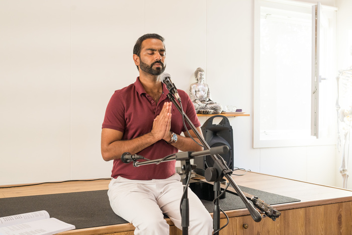 Yoga teacher meditates with hands in prayer position Yoga teacher meditates with hands in prayer position