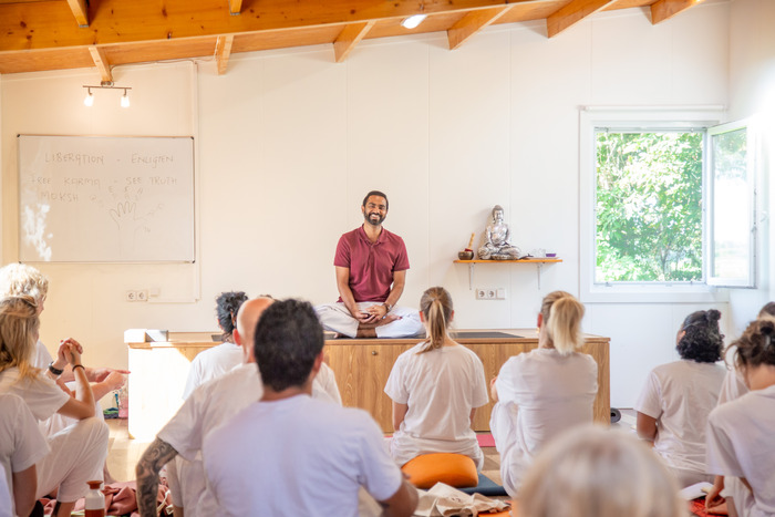Yoga trainer teaches a class of students in India