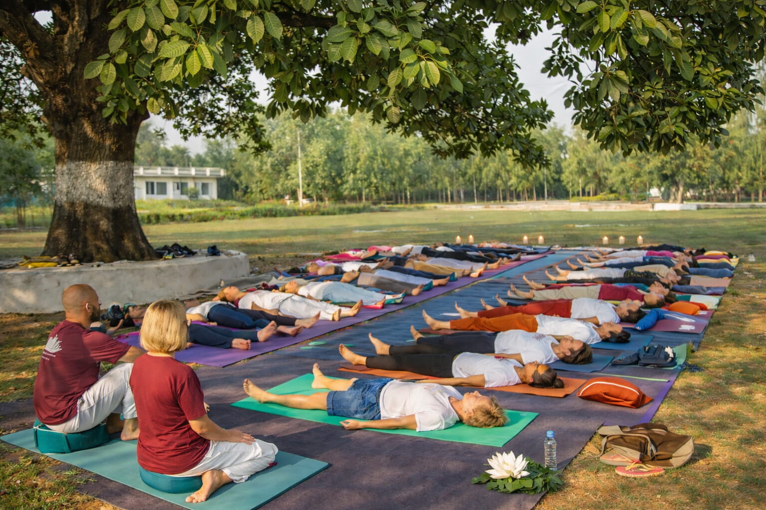 Yoga students lie in corpse pose on a yoga training course in Netherlands