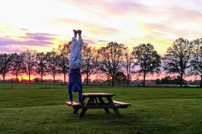 Man performing Handstand or Adho Mukha Vrksasana in an outdoor setup Man performing Handstand or Adho Mukha Vrksasana in an outdoor setup
