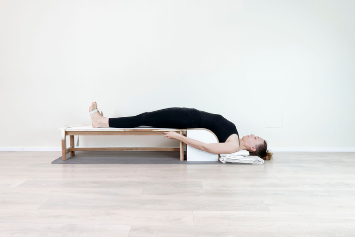 Setu Bandha Sarvangasana supported bridge pose practiced with props