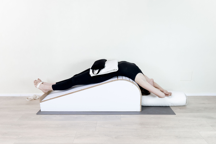 Supported Fish pose with props