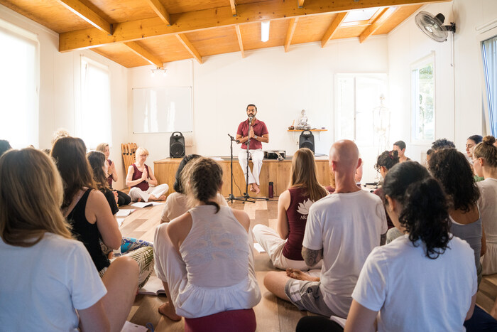 Yoga guru reciting mantras and yoga students following Yoga guru reciting mantras and yoga students following
