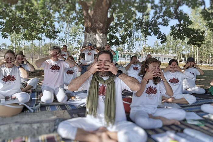 Class of yoga students leaning pranayama outside Class of yoga students leaning pranayama outside