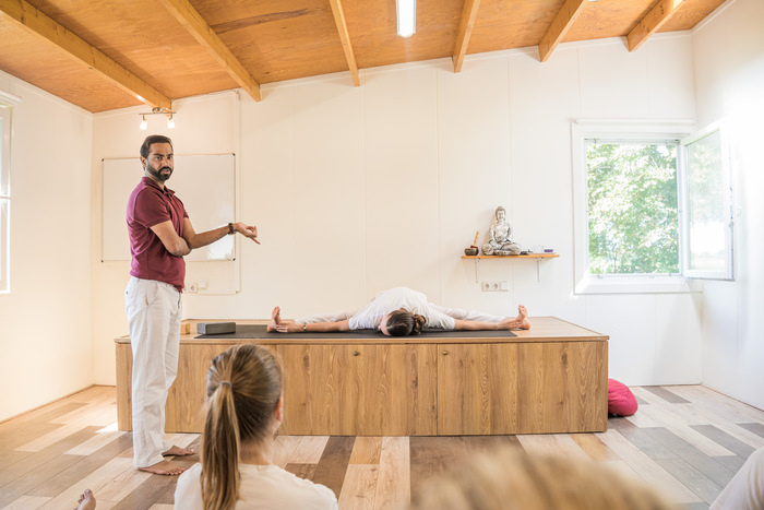 Students practicing Yin variation of Upavistha Konasana